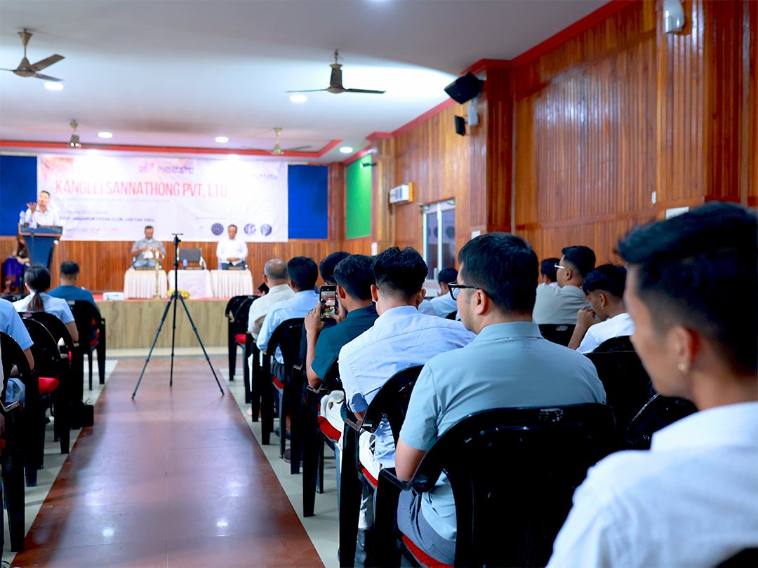 A full hall of attendees seated in rows facing the stage while a speaker addresses them at the Kanglei Sannathong Pvt. Ltd. 2nd anniversary event at the Manipur Press Club in Imphal.